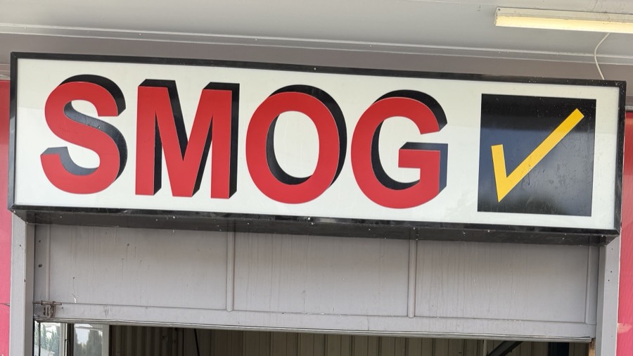 Smog check sign above the bay at Los Angeles STAR Smog Check, Los Angeles
